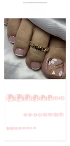 Floral press-on toenails with white petals and gold glitter waves in pink base