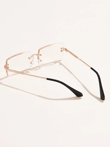 Detailed close-up of rimless square sunglasses with diamond-cut lenses and gold metal temples