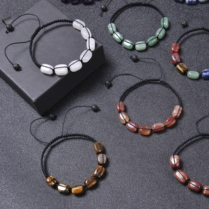 Macro detail of handmade adjustable natural stone bracelets with tiger eye and quartz beads