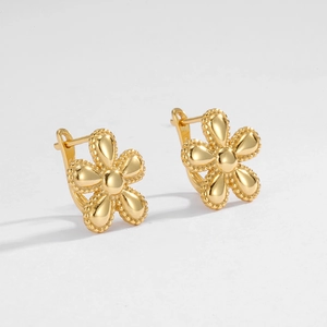 Detail view of S925 silver golden flower stud earrings with milgrain edges and floral texture
