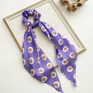 Detail of purple silk scrunchie with coffee cup print on a clean white background