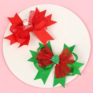 Christmas hair clips set with red and green bows featuring Santa and tree ornaments