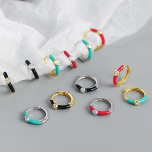 Macro detail of S925 silver huggie earrings with colorful enamel and zircon stones