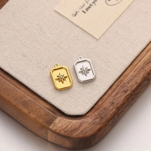 Detailed view of rectangular starburst pendants with small crystals in gold and silver