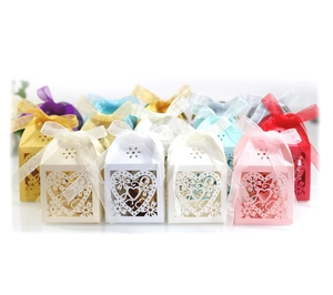 Detailed laser-cut heart patterns on colorful paper gift boxes with organza ribbons