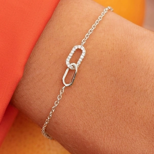 Close-up of interlocking S925 silver loops with sparkling zircon inlay on thin chain