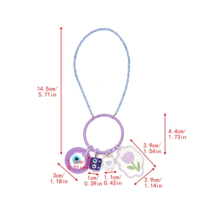 Detail of purple beaded keychain with evil eye, monster cube and tulip charms