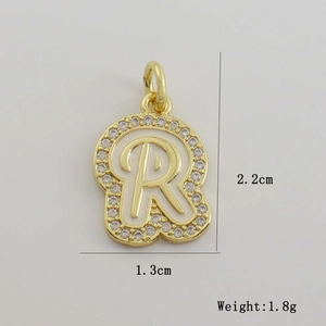 Detail of 18K gold plated letter R pendant with white enamel and sparkling zircon pavé