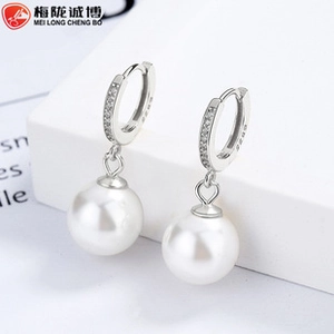 Detailed macro shot of S925 sterling silver bow pearl earrings with zirconia pavé setting