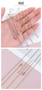 Detail of stainless steel bead chains with lobster clasps in gold and silver finishes