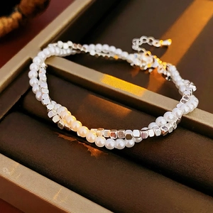 Double-layer pearl and silver beaded bracelet with adjustable chain on jewelry box