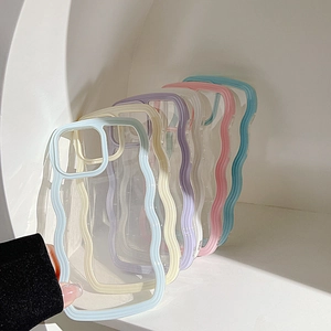 Hand holding a light blue wave frame phone case with multiple pastel colors shown behind