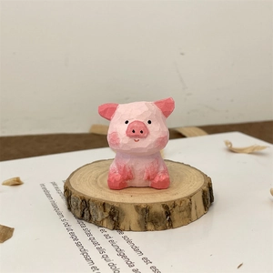 Macro shot of hand-carved pink wooden pig figurine on a rustic studio workbench