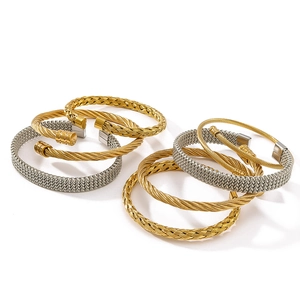 Twisted wire cable open bangle in gold and silver finish with woven steel texture