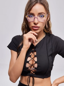 Close-up of purple translucent frame glasses with yellow geometric accents on model