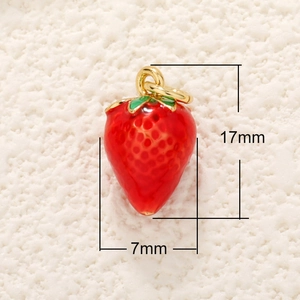 Macro shot of a red strawberry charm pendant with green leaf details and size labels