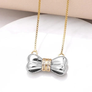 Two-tone bow pendant necklace with micro-pave zircons and golden box chain jewelry