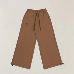 Detail of cargo pants showing adjustable drawstring waist and embroidery on khaki fabric