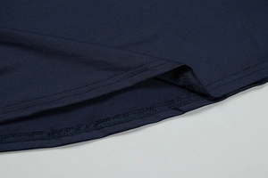 Close-up of durable double-needle stitching on the hem of a dark blue summer dress