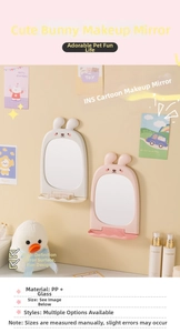 Detail view of rabbit shaped vanity mirror with a small tray for jewelry and brushes