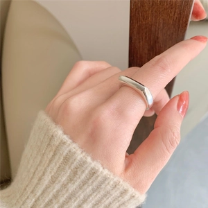 Minimalist 925 sterling silver ring with irregular geometric surface on female hand
