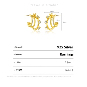 Macro detail of 925 silver C-shape earrings with gold plating and clear zircon stones