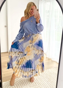 Detailed view of abstract oil painting print and fine pleats on an A-line skirt