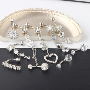 Set of 10 silver navel rings with cubic zirconia in various heart and flower designs