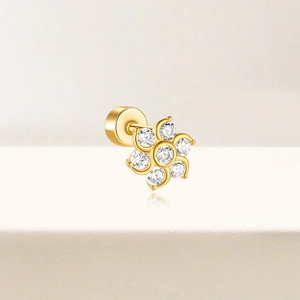 Close-up of golden flower stud earring with clear zircon and secure screw-back ball