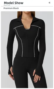 Detail of black yoga jacket featuring white contrast piping and thumbhole cuffs design