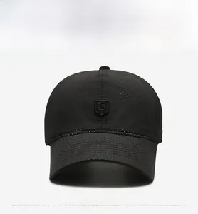 Detail of black breathable mesh baseball cap with shield logo and quick-dry fabric