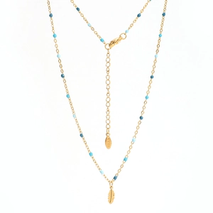 Detail of gold leaf pendant necklace with blue beads and stainless steel hallmark
