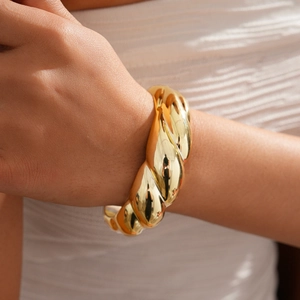 Detailed view of women's gold twisted texture bangle featuring a French vintage style