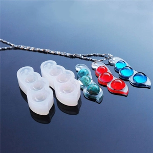 Detailed macro view of pea pod silicone resin molds and finished DIY jewelry pendants