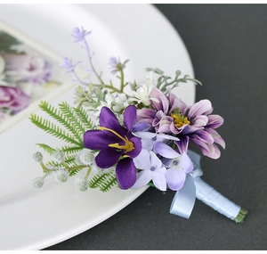 Detail of purple artificial boutonniere with lavender flowers and light blue ribbon bow