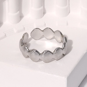 Detail of silver shell relief patterns on an adjustable stainless steel open ring