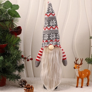 Close-up of Christmas gnome wine bottle cover with grey hat and white snowflake pattern