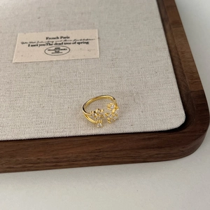 Detail showing the S925 hallmark on a gold-plated butterfly ring with cubic zirconia