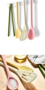 Detail view of colorful heat-resistant silicone kitchen utensil set with magnetic storage