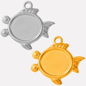 Detail of fish-shaped pendant trays in gold and silver finish for DIY jewelry making