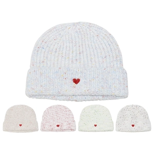 Detailed close-up of ribbed knit beanie texture with a red embroidered heart patch