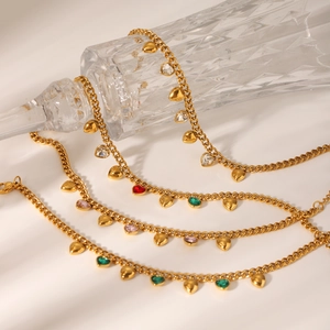 Détail du bracelet gourmette doré avec breloques cœur en zircon coloré sur verre ciselé