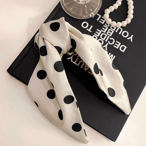 Polka dot silk bow hair claw clip with pearls and elegant accessories in retro style