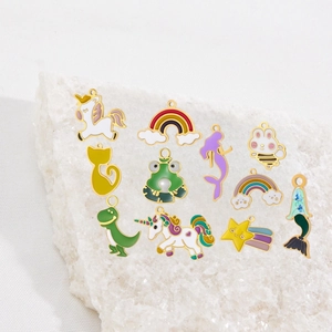 Colorful enamel unicorn and mermaid charms with gold borders on white crystal rock