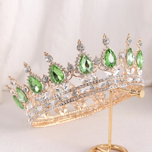 Detail of baroque bridal crown with green teardrop rhinestones and gold metal finish