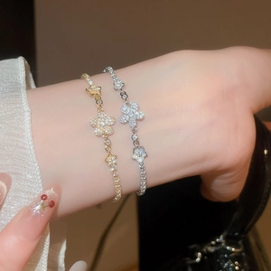 Close-up of sparkling zircon flower bracelet with gold and silver plated finish