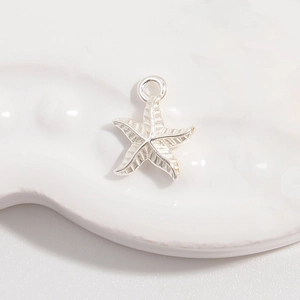Detailed view of an S925 sterling silver starfish pendant with shimmering cubic zirconia