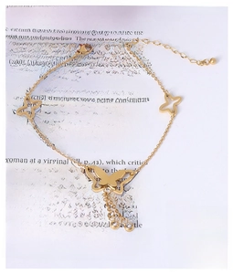 Detail of gold butterfly anklet with sparkling crystal charms and adjustable link chain
