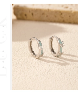 Detailed close-up of s925 silver butterfly earrings with mint green enamel inlay