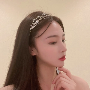 Detail of layered gold star headband with rhinestones on a female model profile